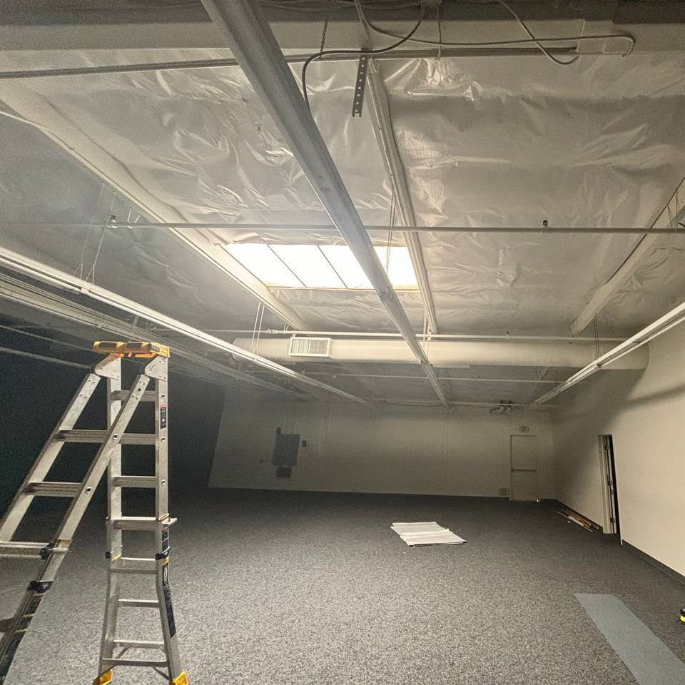 Office ceiling lined with white-faced radiant barrier insulation.